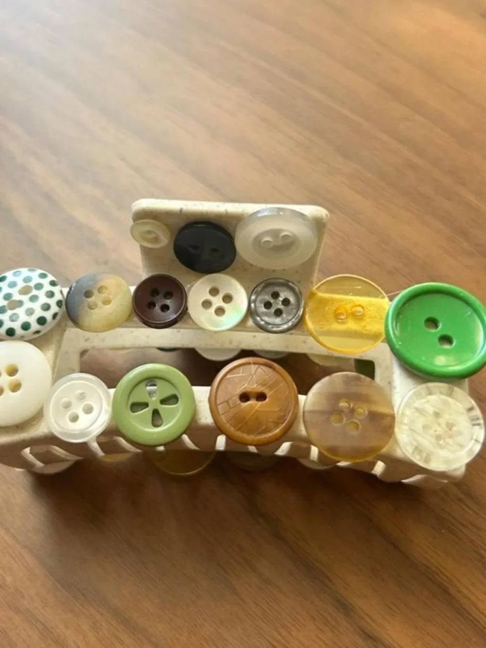 Multi-colored button hair clip with assorted buttons in various sizes and colors